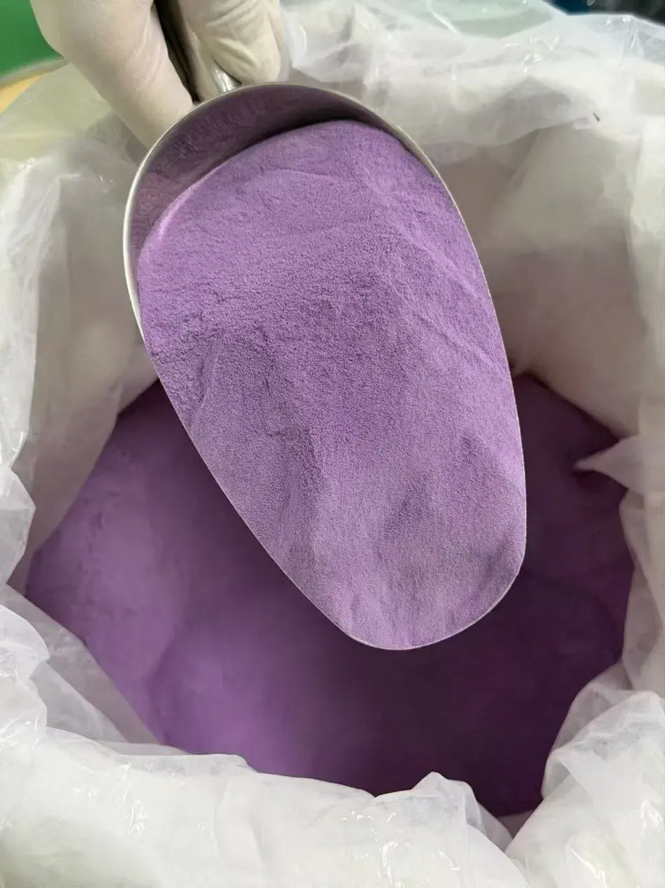 Drum-dried ube powder, pale lilac on the scoop surface and a deeper violet in the bag below